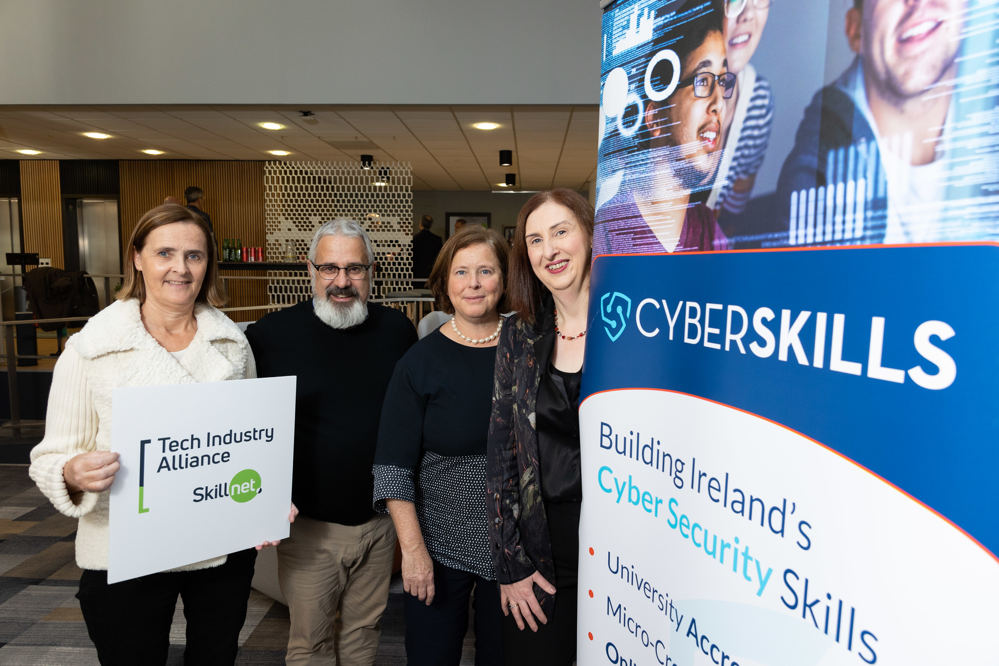 4 people standing indoors cyber security courses